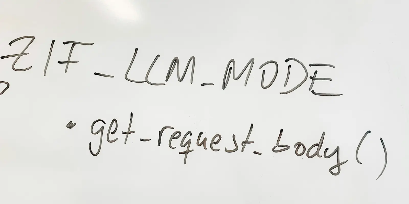 Close-up of an office whiteboard with black marker handwriting reading IF_LLM_MODE in capitals, and below it, in cursive, a bullet point and get-request_body with brackets